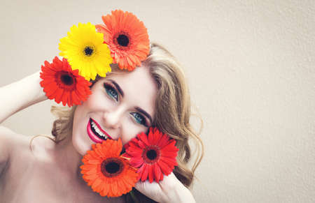 Beautiful girl with a nice flowers in handsの写真素材