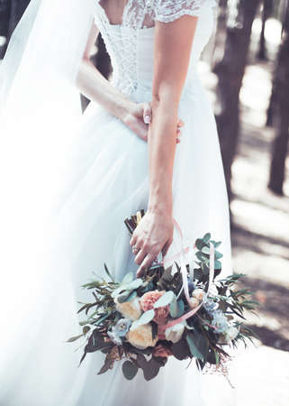 Bride in a white dress and with a beautiful bouquetの写真素材