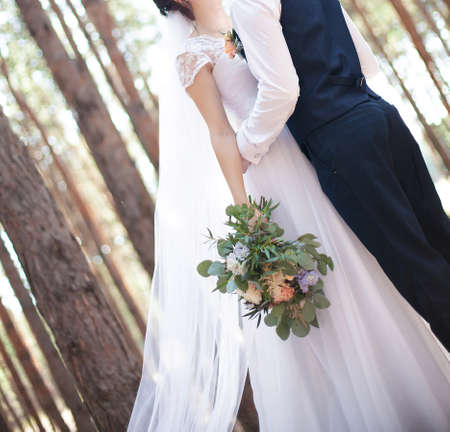 Young pair in strong embraces in the wedding dayの写真素材
