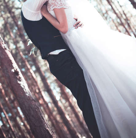 Young pair in strong embraces in the wedding dayの写真素材