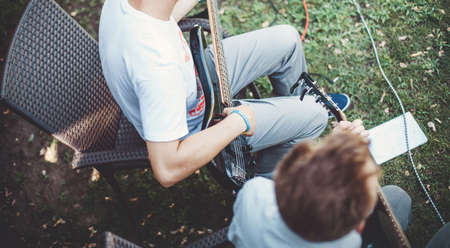 The guy playing on the black guitar in a musical groupの写真素材