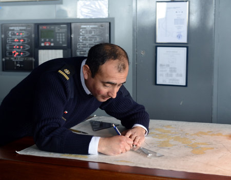 The senior Navigator of the ship "Via Australis" paving the sea route on the map from Cape horn.のeditorial素材