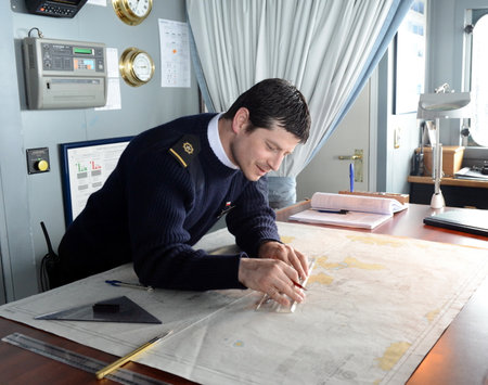 The Navigator of the ship "Via Australis" paving the sea route on the map from Cape horn.のeditorial素材