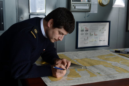 The navigator of the ship "Via Australis" paves the sea route map in the archipelago of Tierra del Fuego.のeditorial素材