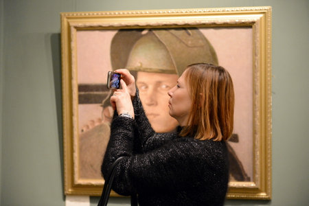 A spectator photographs the exhibition at the Moscow state school of watercolour of Sergei Andriyaka in Gorokhovsky lane.のeditorial素材