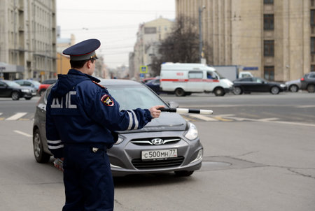 The inspector of traffic police stops a car on the Garden ring.