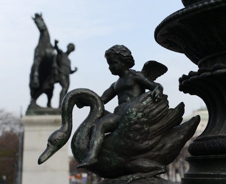 Cupid on a swan, bronze statue decoration of old street lamp near Austrian Parliament Building, Vienna, Austria. It was erected in 1900.のeditorial素材