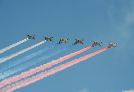 A group of assault plane Sukhoi Su-25 Grach (NATO reporting name: "Frogfoot") in the sky smoke flag of the Russian flag at the rehearsal of parade dedicated to Victory Dayのeditorial素材