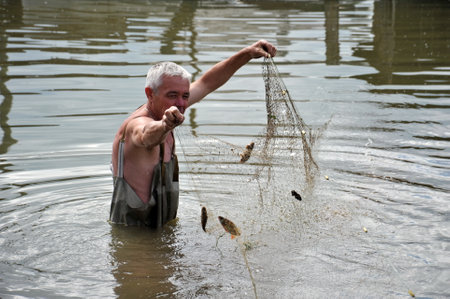 Local resident fishing network during the flood in the garden.のeditorial素材