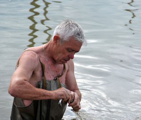Local resident fishing network during the flood in the garden.のeditorial素材