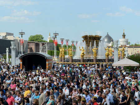 People during the celebration of Victory Day are watching the concert at the Exhibition of Economic Achievements.のeditorial素材