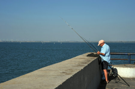 Fishermen are fishing in the harbor of the seaport of Cadiz.のeditorial素材