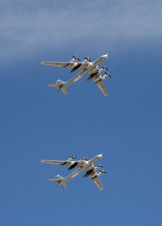 A group of turboprop strategic bombers Tu-95 MS fly over Red Square on the parade dedicated to the...