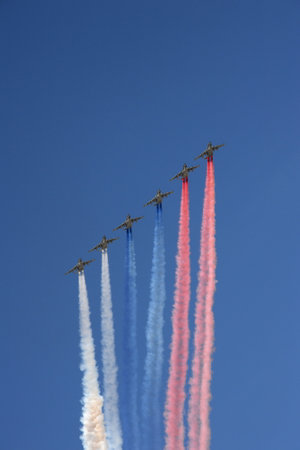 A group of Su-25 "Grach" attack aircraft smoke the colors of the Russian flag in the sky over Red Squareのeditorial素材