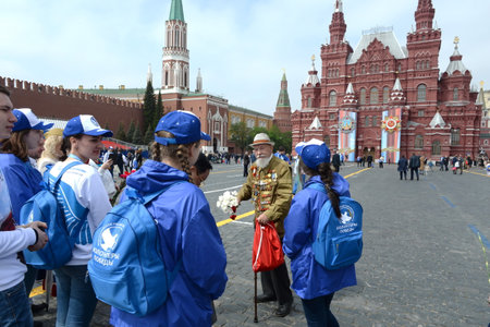 Great Patriotic war veteran Vladimir Burkov on the red square of Moscow with volunteers during the...