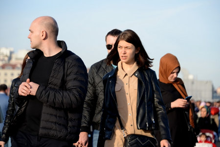 People walk on a holiday on the Galata bridge over the Golden horn Bay in Istanbul