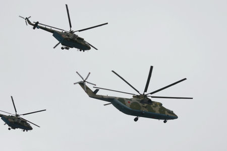 Mi-26 military transport and Mi-8AMTSH multi-purpose helicopters during an air parade on May 9 Victory Day in Moscowのeditorial素材