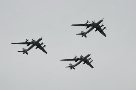 A group of turboprop strategic bombers Tu-95MS fly over Red Square in an air parade dedicated to the...