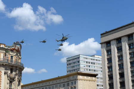 Military transport Mi-26 and multi-purpose Mi-8AMTSH helicopters in the sky over Moscow during the parade dedicated to the 75th anniversary of victory In the great Patriotic warのeditorial素材