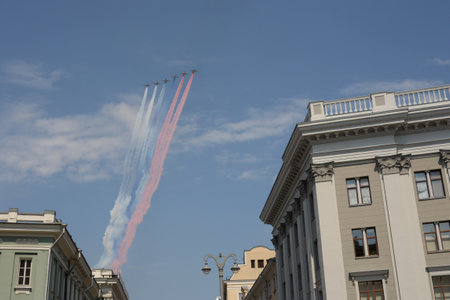 A group of su-25 Grach attack aircraft smoke the colors of the Russian flag in the sky over Moscow during the dress rehearsal of the Victory paradeのeditorial素材