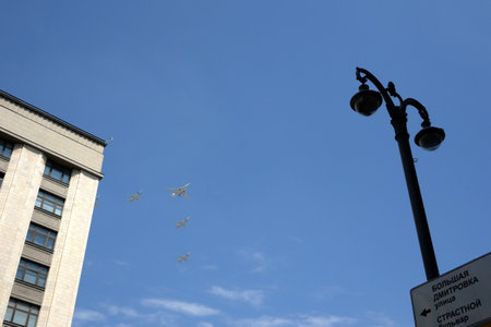 A group of Tu-22M3 strategic missile carriers with variable wing geometry and a Tu-160 supersonic long-range strategic bomber in the sky over Moscowのeditorial素材