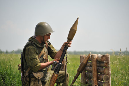A grenade launcher warrior at the shooting range is preparing to fire a shotのeditorial素材