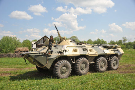 BTR-80 military armored personnel carrier on the outskirts of a village