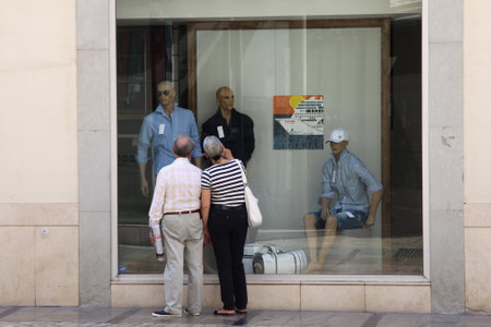 An elderly couple at a shop window