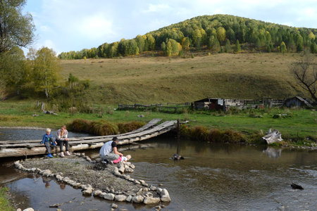 Local residents relax on the mountain river Irovka in the taiga village of Generalka of the Altai Territoryのeditorial素材