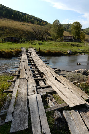 Bridge over the mountain river Yarovka in the taiga village of Generalka, Altai Krai