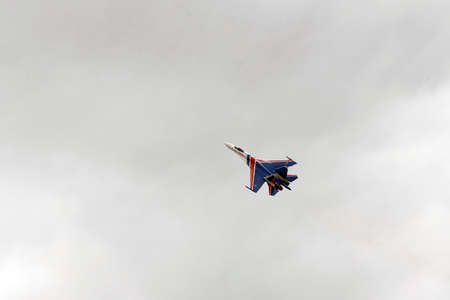 The SU-35S multi-purpose fighter from the Russian Knights aerobatics group in the sky at the...