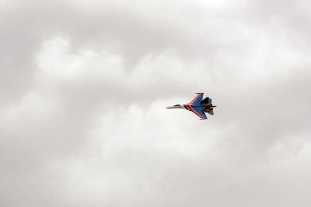 The SU-35S multi-purpose fighter from the Russian Knights aerobatics group in the sky at the...