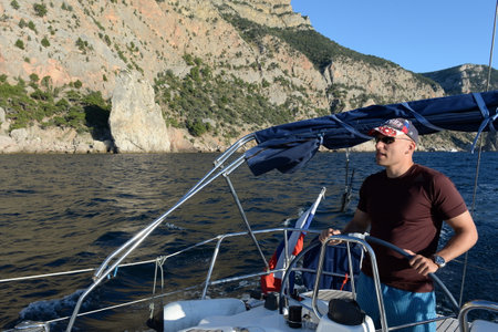 Yacht captain at the rocks of Cape Aya in the vicinity of Balaklava, Sevastopol, Crimean Peninsula