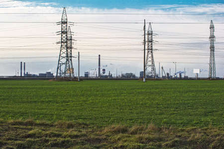 Industrial landscape - green field and industrial construction の写真素材