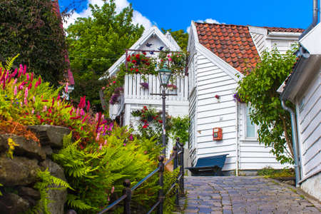 Old street with white wooden houses with tiled roofs in the center of Stavanger, Norway.の写真素材