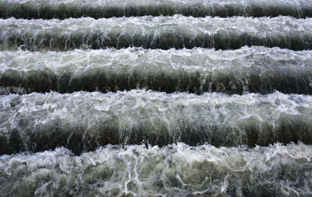 Rapid stream of water flowing in the bottom step  