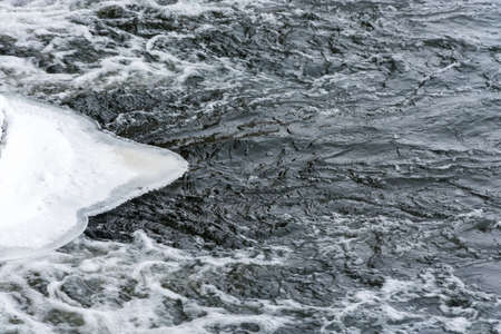 White ice and boiling, rapid, foamy stream of water.の写真素材