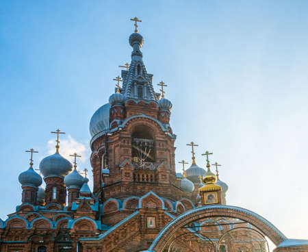 Blue Church domes with gold crosses on blue sky background.の写真素材