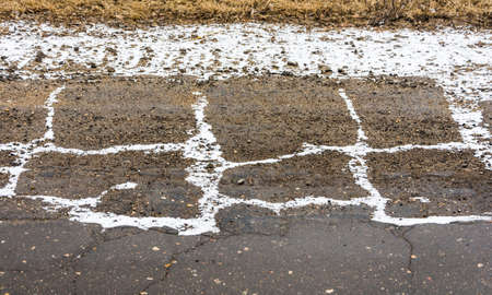 Snow white painted rectangles on the side of the road.の写真素材