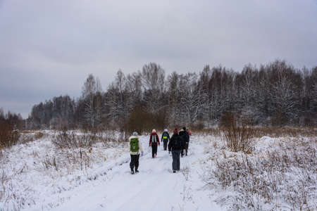 Tourists are on the road in a snowy forest.の写真素材