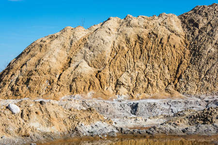 Large mountains of sand mixed with salt for filling of roads in the winter.の写真素材