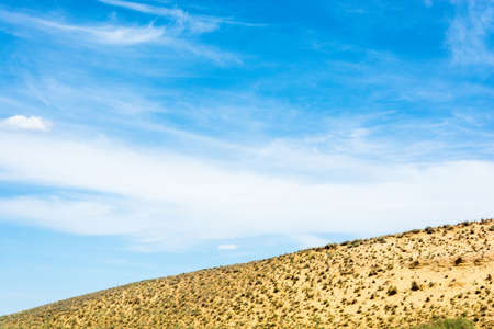 Beautiful blue sky with clouds and the salt marshes against the yellow earth.の写真素材