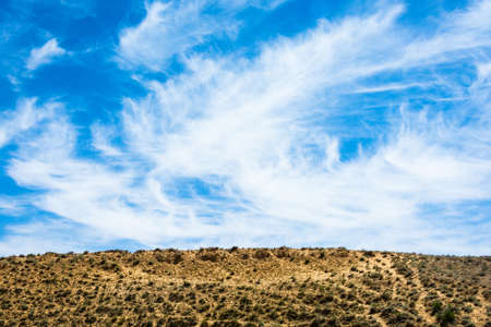 Beautiful blue sky with clouds and the salt marshes against the yellow earth.の写真素材