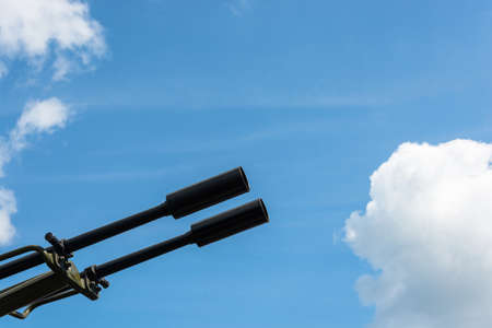 The gun barrel against cloudy sky close-up shot.の写真素材