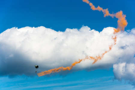 Parachutists descending on the background of beautiful cloudy sky on a Sunny day.のeditorial素材