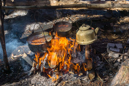 On a Hiking fire prepared a delicious lunch. Filmed close-up.の写真素材