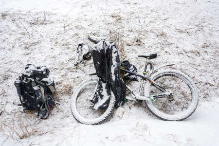 Lying on the ground the bike included a light fluffy snow.の写真素材