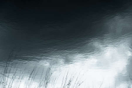 Abstraction. Beautiful and magical reflection in the water of the sky and trees. の写真素材