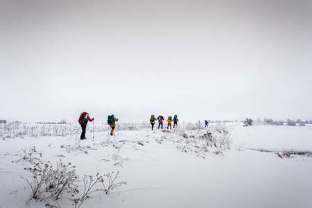 A small group of tourists in ski trip February day.