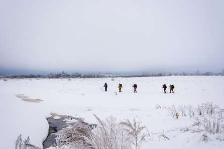 A small group of tourists in ski trip February day.の写真素材